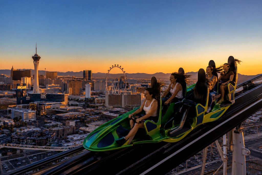 Roller coaster riders in Las Vegas sunset