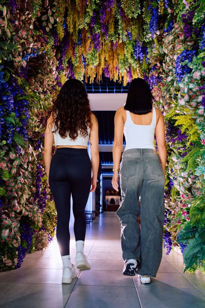 Shoppers walking through the flower tunnel entrance at Wallflower Cannabis House